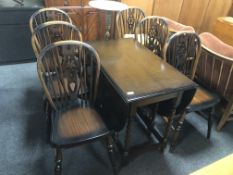 A gateleg table together with a set of six Windsor chairs