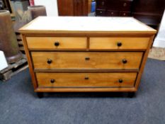 A continental satin wood four drawer chest together with a pair of matching bedside cupboards