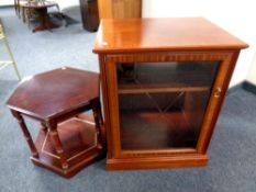 An audio cabinet in a mahogany finish together with two tier table