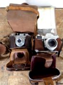 A small group of vintage cameras including Comet,