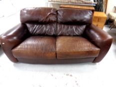 A contemporary brown leather two seater settee