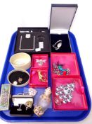 A tray of costume brooches, cufflinks,