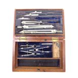 An antique precision drawing set in stained pine box