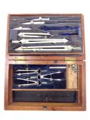 An antique precision drawing set in stained pine box