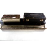 A Hohner bass harmonica in box plus one other