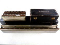 A Hohner bass harmonica in box plus one other