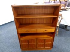 A 20th century Nathan teak book shelf with drawer and double cupboard beneath