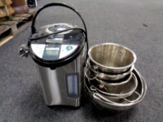 An Neostar water boiler together with three stainless steel champagne buckets and two jam pans