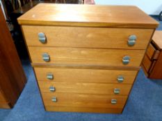 A 20th century teak five drawer chest