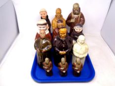 A tray of china decanters in the form of monks