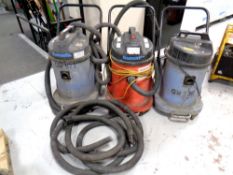 Three commercial Numatic vacuums 110 v, together with a crate of hoses.