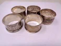 Three hallmarked silver napkin rings together with a pair of Indian white metal napkin rings