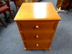 A Stag three drawer bedside chest in teak finish