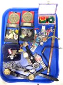 A tray of lady's and gent's wrist watches, enamelled badges,