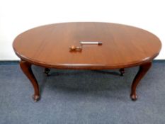 A mahogany extending oval dining table together with set of four stained pine dining chairs