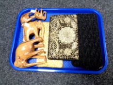 A tray of wooden elephant figures and lady's beaded evening bags.