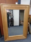 A contemporary light oak mirror.