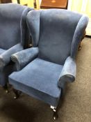A Parker Knoll blue upholstered wing armchair.