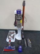 A Dyson cordless vacuum on stand with accessories