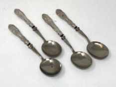 Four spoons with silver handles