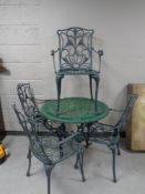 A metal five piece patio set comprising of table and four chairs.