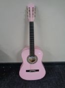A Herald pink acoustic guitar.