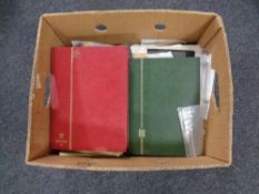 A box of stamps and stamp albums.