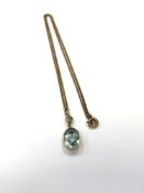 An antique yellow metal mounted aquamarine pendant and chain