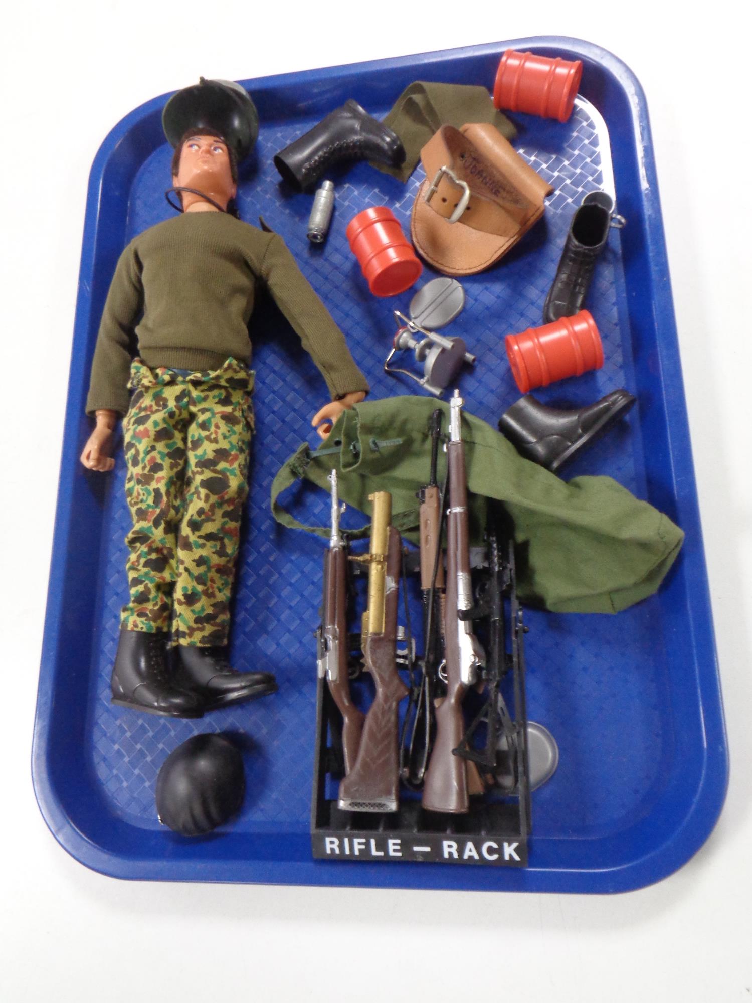 A vintage action man together with accessories including rifle rack, machine gun,