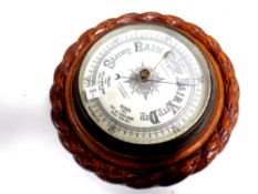 A carved oak barometer