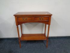 A yew wood two drawer side table.