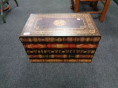 A storage box in the form of a large stack of books.