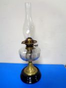 A Victorian oil lamp with glass chimney.
