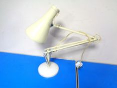 A cream angle poise lamp.