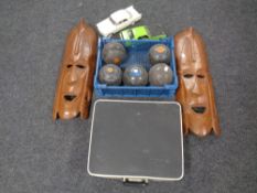 Two African wooden plaques together with a box of lawn bowls, two model cars and a typewriter.