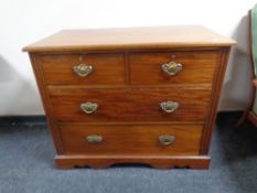 An Edwardian mahogany four drawer chest.