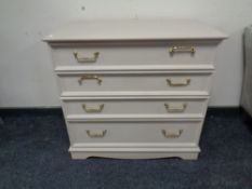 A reproduction four drawer chest with brass handles.