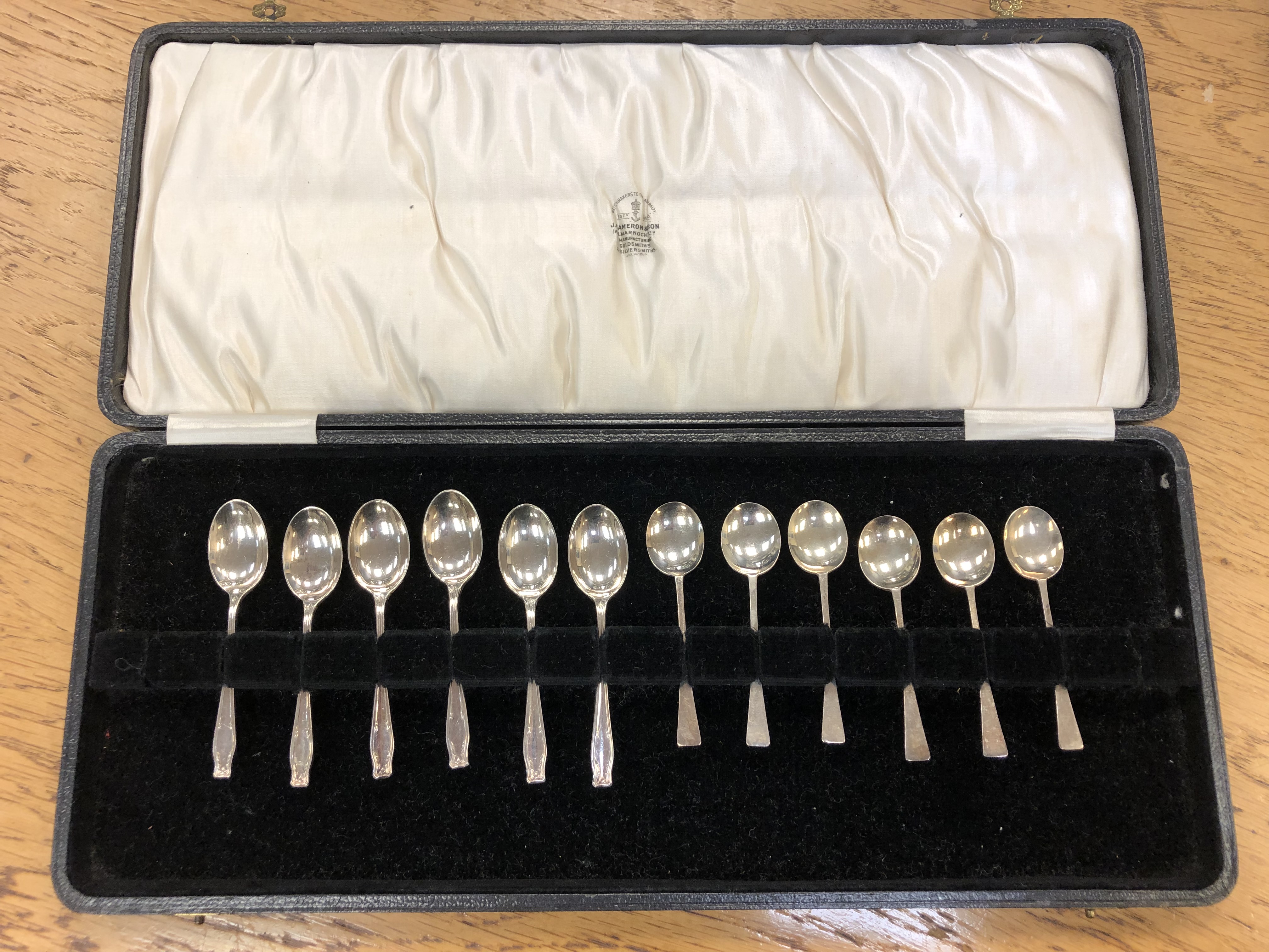 Two sets of six silver teaspoons in associated box.
