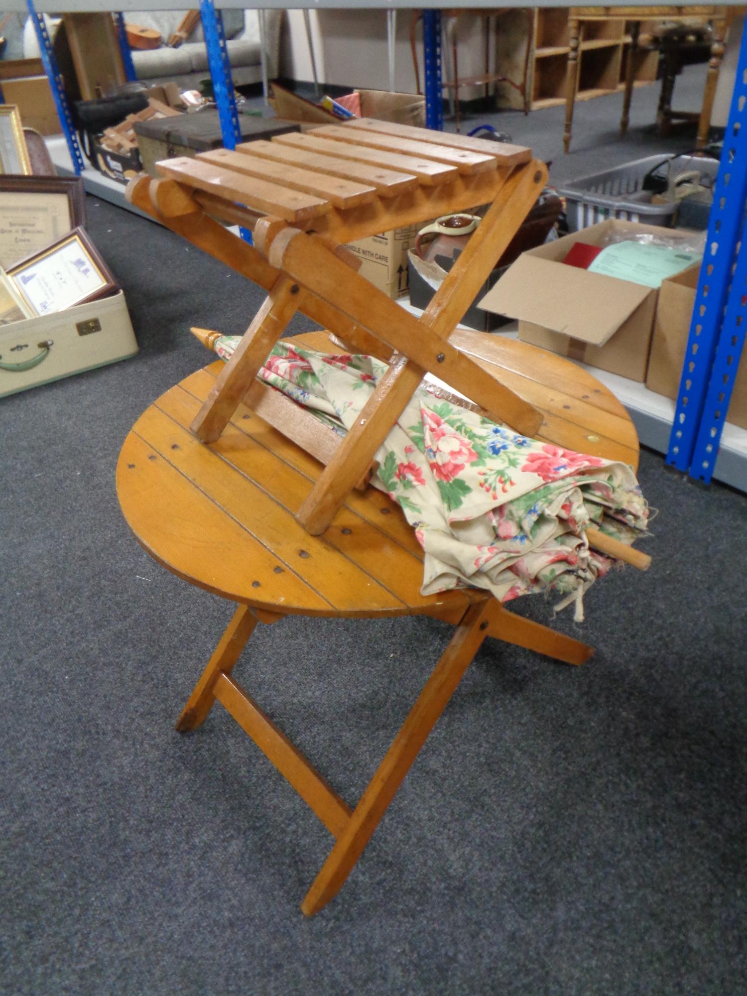 A child's folding table with parasol and stool.