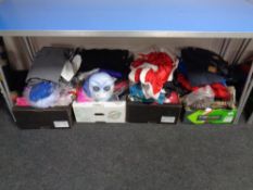 Four boxes containing fancy-dress costumes.