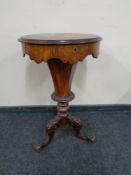 A Victorian walnut sewing table.