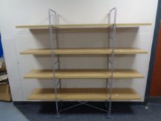 A contemporary four tier light oak effect shelf.