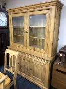 A contemporary light oak bookcase fitted with three drawers and cupboards below.