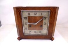 A 1920's walnut cased mantel clock.