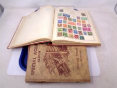 A Strand stamp album, stamps of the world, together with further stamp books and folder of stamps.