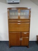 A mid-century kitchen cabinet with fitted interior.
