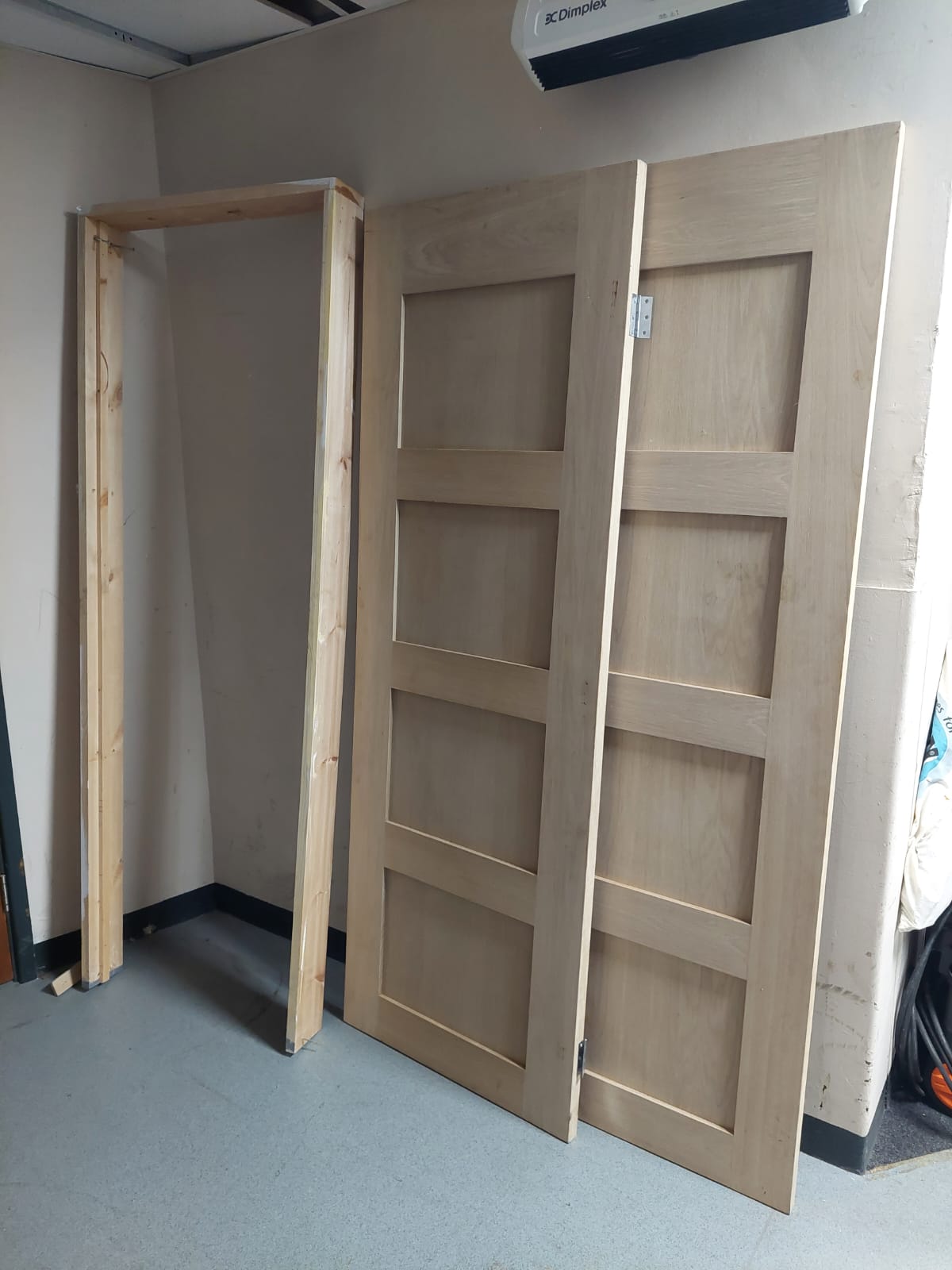 Two oak internal doors together with a frame.