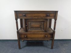 An antique style oak side cabinet fitted with two drawers.