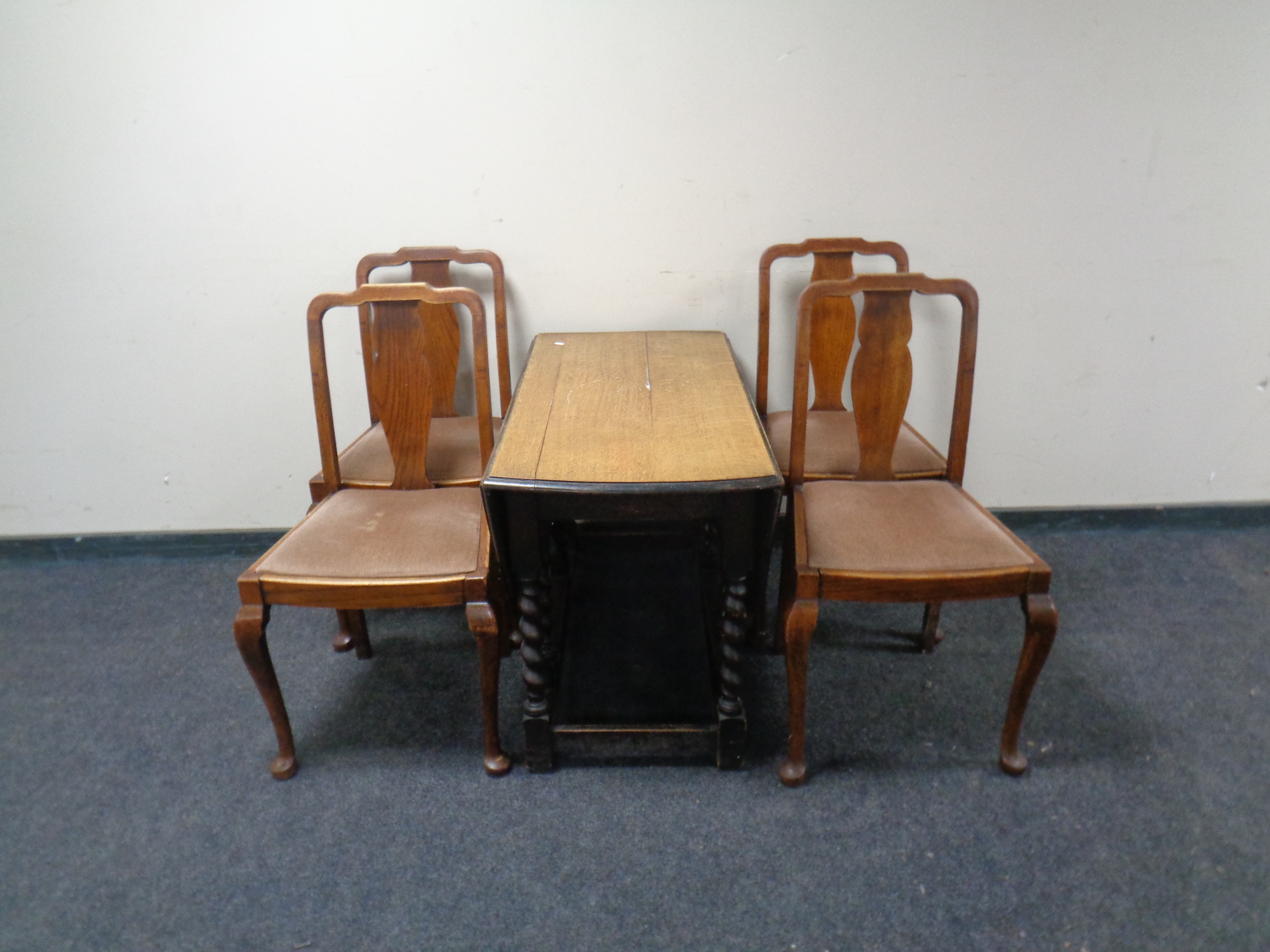 An oak gateleg table and four chairs.