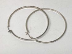 A pair of large silver hoop earrings
